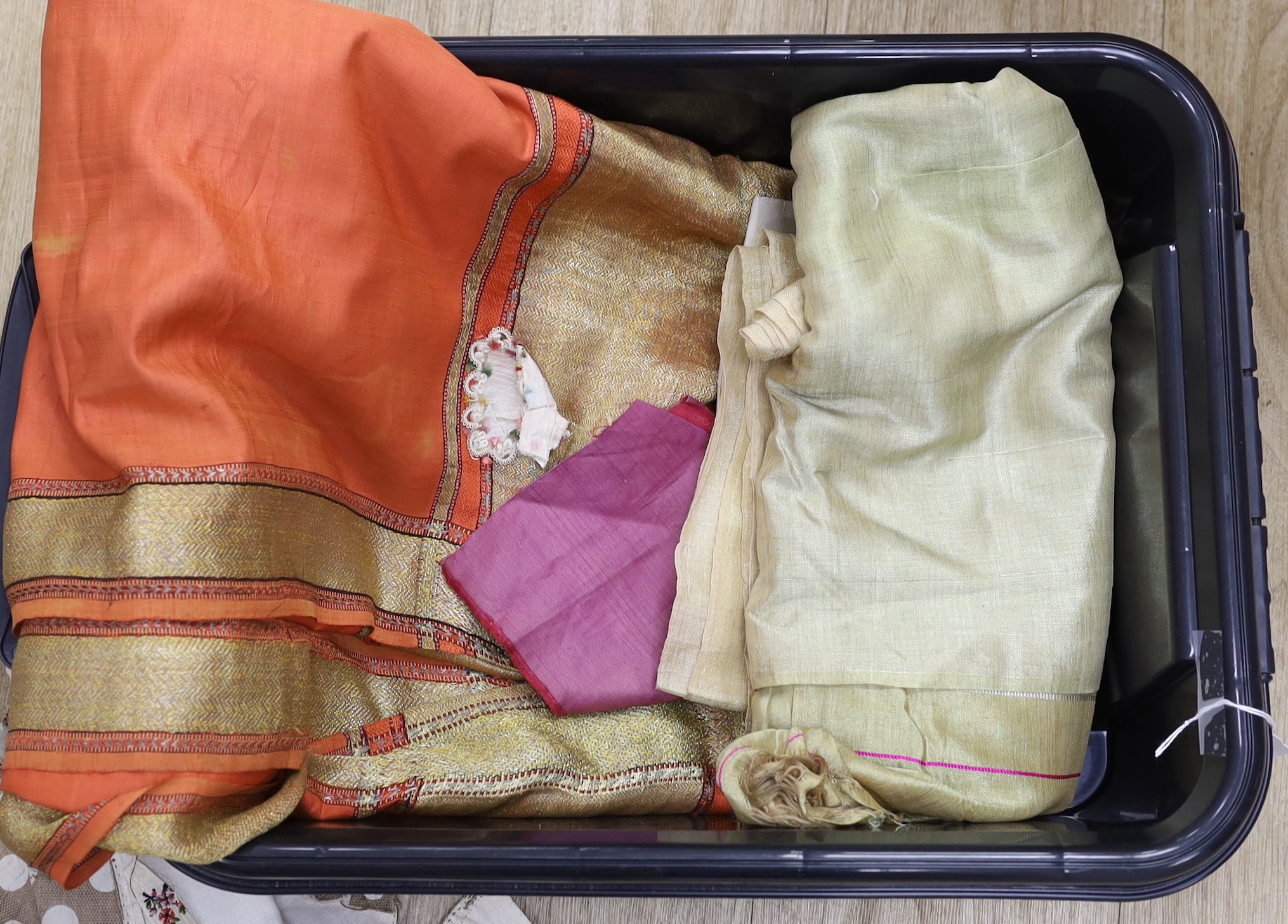 An Indian peach silk sari with woven gold borders, a fine woven gold coloured sari and part of an unmade late 18th / early 19th century ladies silk striped dress (in pieces)